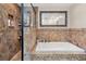 Elegant bathroom with a separate shower, soaking tub, and tiled surround at 4604 Barbados Loop, Clermont, FL 34711