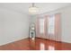 A bed room with a mirror, pink curtains, and wood floors at 4604 Barbados Loop, Clermont, FL 34711