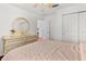 A bedroom with a large bed, ceiling fan, closet and wood floors at 4604 Barbados Loop, Clermont, FL 34711