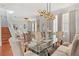 Bright dining area featuring a glass table, seating for eight, and elegant decorations at 4604 Barbados Loop, Clermont, FL 34711