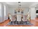 Formal dining room features a modern chandelier, plush chairs, and elegant decor at 4604 Barbados Loop, Clermont, FL 34711