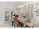 Dining room with elegant chandelier, French doors, and neutral color palette at 4604 Barbados Loop, Clermont, FL 34711