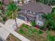 Beautiful two-story home features a well-maintained lawn, two car garage, and mature tropical landscaping at 4604 Barbados Loop, Clermont, FL 34711