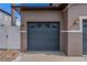 A blue two car garage door with decorative windows and carriage house style lighting at 4604 Barbados Loop, Clermont, FL 34711