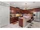 Well-equipped kitchen with rich wood cabinets, stainless steel appliances, and a breakfast bar at 4604 Barbados Loop, Clermont, FL 34711