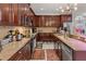 Gourmet kitchen with granite countertops, stainless steel appliances, and custom cabinetry at 4604 Barbados Loop, Clermont, FL 34711