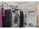 A laundry room with stainless steel washer and dryer, storage, and a window at 4604 Barbados Loop, Clermont, FL 34711