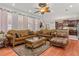 Cozy living room with hardwood floors, plush seating, and an open view to the kitchen at 4604 Barbados Loop, Clermont, FL 34711