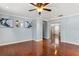 Bright living room with wood floors, neutral paint, ceiling fan and an open layout at 4604 Barbados Loop, Clermont, FL 34711
