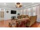 Elegant living room with hardwood floors, floral accents, and comfortable seating at 4604 Barbados Loop, Clermont, FL 34711