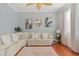 Comfortable living room area featuring a large sofa and natural lighting at 4604 Barbados Loop, Clermont, FL 34711