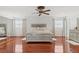 Expansive main bedroom with wood floors, large bed, ceiling fan and natural light at 4604 Barbados Loop, Clermont, FL 34711