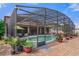 Screened pool area with outdoor seating, lush landscaping, and a sparkling pool at 4604 Barbados Loop, Clermont, FL 34711