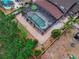Aerial view of the backyard, showcasing a screened pool and brick-paved deck surrounded by lush landscaping at 4604 Barbados Loop, Clermont, FL 34711