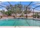Stunning screened-in pool with a tranquil waterfall, creating a private backyard oasis at 4604 Barbados Loop, Clermont, FL 34711