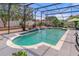 Inviting screened-in pool with a serene waterfall feature, perfect for relaxation and enjoyment at 4604 Barbados Loop, Clermont, FL 34711
