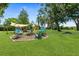 Spacious backyard featuring a fire pit and stylish swing chairs, ideal for outdoor gatherings and relaxation at 51 Silk Moss Ct, South Daytona, FL 32119