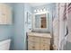 Traditional bathroom with framed mirror, granite countertop, and a shower-tub combo at 51 Silk Moss Ct, South Daytona, FL 32119