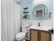 Cozy bathroom with shelves and a rattan-front vanity at 51 Silk Moss Ct, South Daytona, FL 32119