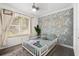 Bright room with Japanese wave wallpaper and a stylish white bed frame at 51 Silk Moss Ct, South Daytona, FL 32119