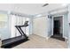 Inviting exercise space with a treadmill, wood flooring, and access to additional rooms at 51 Silk Moss Ct, South Daytona, FL 32119