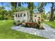 Charming exterior with beautiful landscaping, a paved path, and a well-maintained lawn at 51 Silk Moss Ct, South Daytona, FL 32119