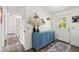 Hallway featuring stylish blue cabinet, decor, and clean, bright design leading to exterior door at 51 Silk Moss Ct, South Daytona, FL 32119
