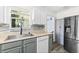 Bright kitchen with stainless steel appliances, white cabinets, and modern faucet at 51 Silk Moss Ct, South Daytona, FL 32119