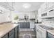 Well-lit kitchen with white cabinets, stainless steel appliances, and decorative tile backsplash at 51 Silk Moss Ct, South Daytona, FL 32119