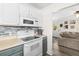 Cozy kitchen features modern appliances, blue backsplash, and white cabinets for a clean, stylish look at 51 Silk Moss Ct, South Daytona, FL 32119