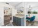 Open kitchen and dining area featuring modern appliances, stylish cabinets, and pass-through counter at 51 Silk Moss Ct, South Daytona, FL 32119