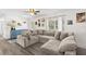 Comfortable living room with oversized sectional, bright natural light, and view of entry way at 51 Silk Moss Ct, South Daytona, FL 32119