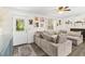 Inviting living room featuring a large sectional sofa, natural light, and stylish decor at 51 Silk Moss Ct, South Daytona, FL 32119