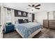 Spacious main bedroom with a ceiling fan, bedside table, and dual dressers at 51 Silk Moss Ct, South Daytona, FL 32119