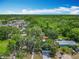 Expansive aerial view of a home featuring lush greenery, nearby apartments, and serene blue skies at 511 Doctors Dr, Oviedo, FL 32765