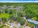 Aerial shot of a home with a well-maintained yard, complementing nearby apartments and lush landscapes at 511 Doctors Dr, Oviedo, FL 32765
