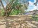 The large backyard, shaded by mature trees, offers a serene outdoor space at 511 Doctors Dr, Oviedo, FL 32765