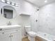 Modern bathroom with marble tile shower, floating shelf, and updated fixtures at 511 Doctors Dr, Oviedo, FL 32765