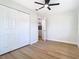 Bedroom featuring hardwood floors, closet, and a modern ceiling fan at 511 Doctors Dr, Oviedo, FL 32765