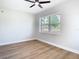 Bedroom featuring hardwood floors, a large window, and a modern ceiling fan at 511 Doctors Dr, Oviedo, FL 32765