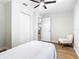 A bedroom featuring wood floors, a ceiling fan and a stylish chair at 511 Doctors Dr, Oviedo, FL 32765