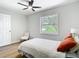 Bedroom with hardwood floors, window view, ceiling fan and cozy bed with pillows at 511 Doctors Dr, Oviedo, FL 32765