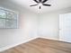 Bedroom featuring hardwood floors, a door, a window, and a ceiling fan at 511 Doctors Dr, Oviedo, FL 32765