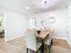 Cozy dining room with a rustic wooden table, upholstered chairs, and neutral decor at 511 Doctors Dr, Oviedo, FL 32765