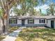 Charming single-story home featuring a stone accent wall and a well-manicured front yard at 511 Doctors Dr, Oviedo, FL 32765
