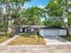 Inviting single-story home with a front-facing garage, a gravel walkway, and well-manicured front yard at 511 Doctors Dr, Oviedo, FL 32765