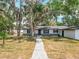 Inviting single-story home with a gravel walkway leading to the front door and well-kept landscaping at 511 Doctors Dr, Oviedo, FL 32765