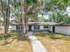 Charming single-story home featuring a welcoming walkway, and lush trees providing ample shade at 511 Doctors Dr, Oviedo, FL 32765