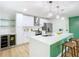 Open-concept kitchen featuring a wine cooler, quartz counters, stainless steel appliances and island seating at 511 Doctors Dr, Oviedo, FL 32765