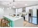 Modern kitchen with white cabinets, stainless steel appliances, and a center island at 511 Doctors Dr, Oviedo, FL 32765